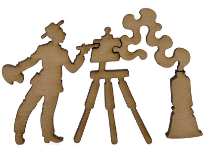 A closeup of pieces shaped like a painter, easel, and a tube of paint.