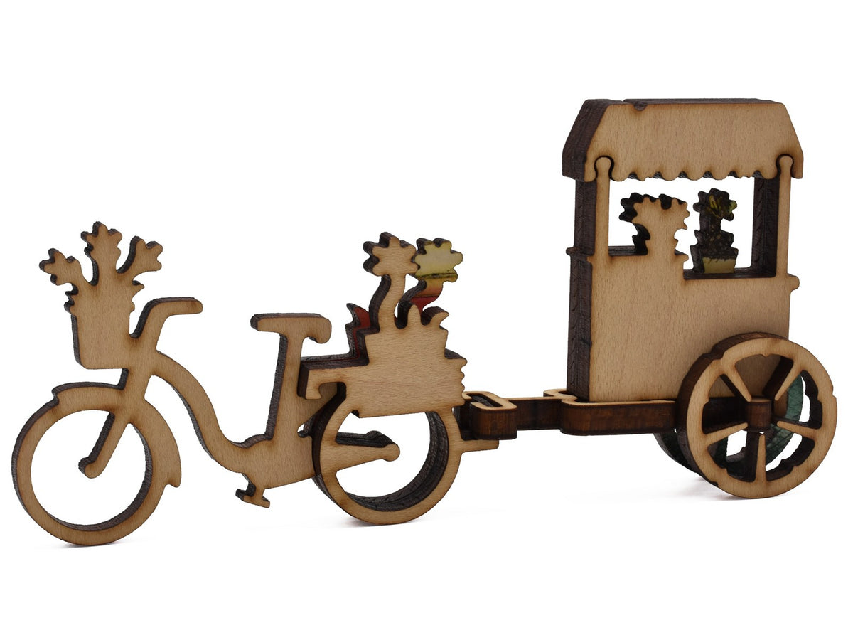 A closeup of pieces shaped like a three dimensional bike with flower cart.