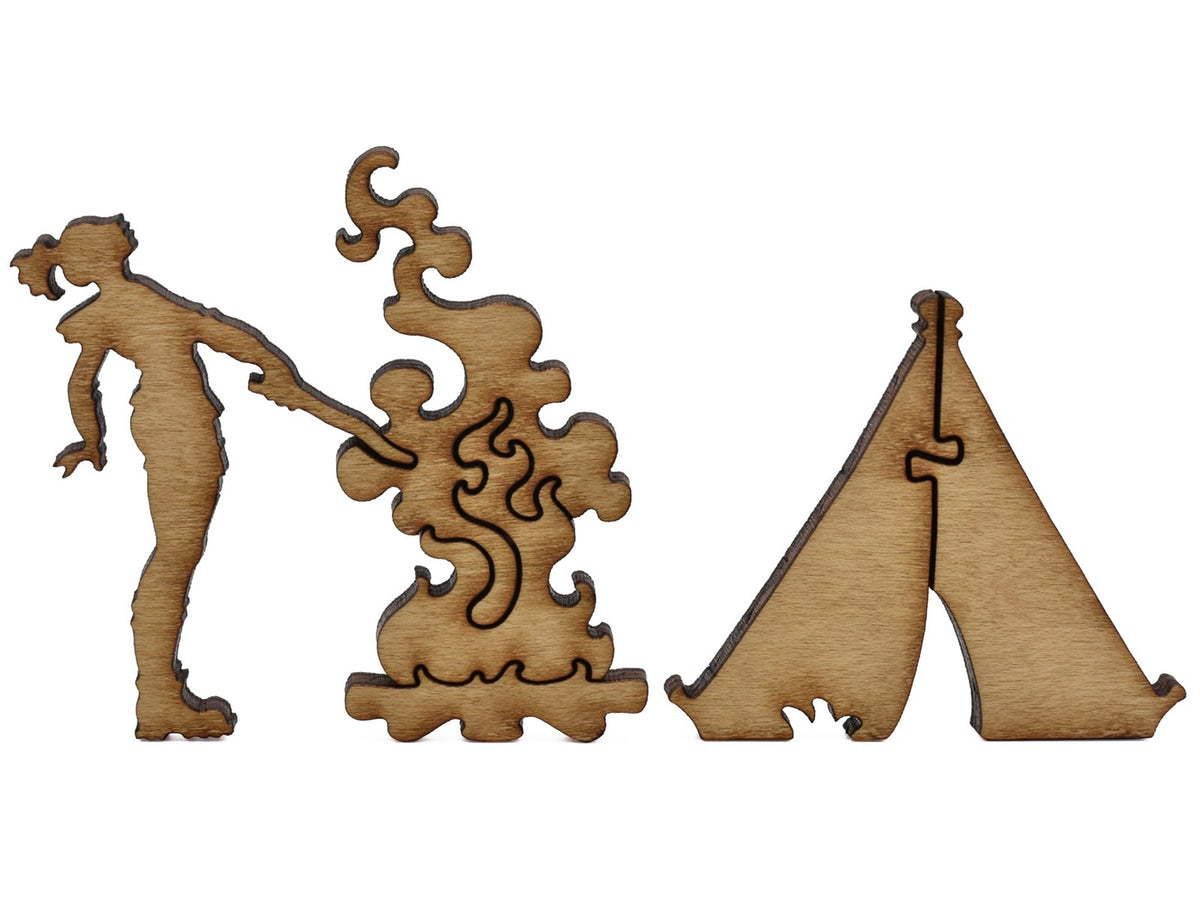 A closeup of pieces shaped like a woman tending to a campfire next to a tent.