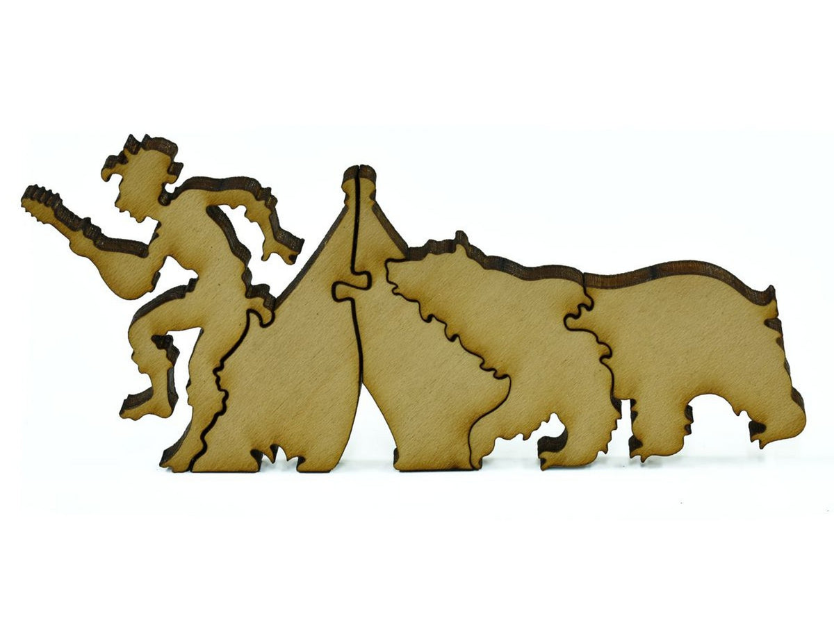 A closeup of pieces in the shape of a bear next to a camper.