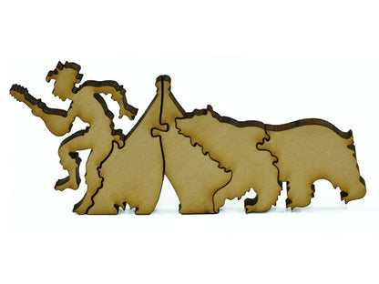 A closeup of pieces in the shape of a bear next to a camper.