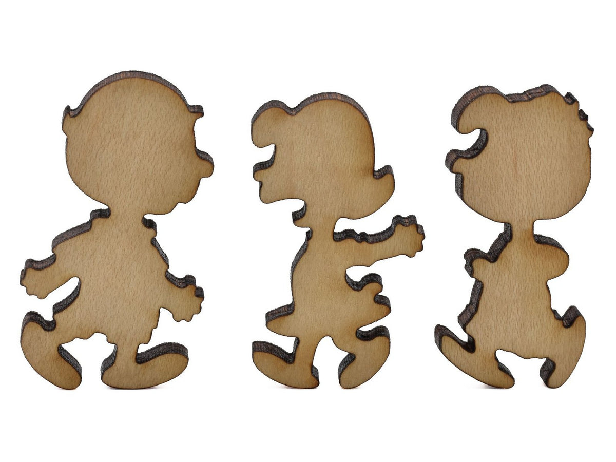 A closeup of pieces shaped like Charlie Brown, Lucy, and Schroeder.