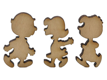 A closeup of pieces shaped like Charlie Brown, Lucy, and Schroeder.