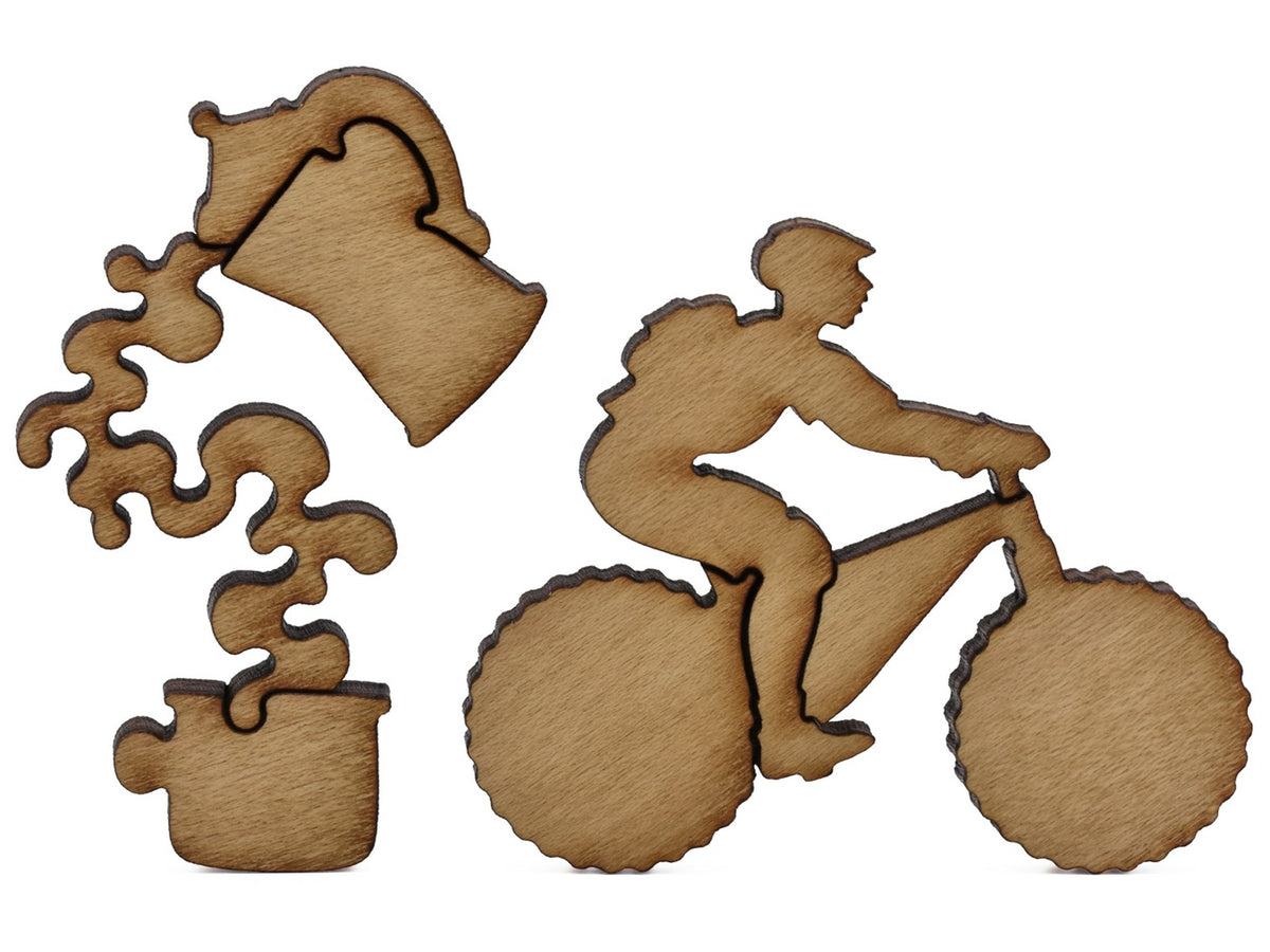 A closeup of pieces shaped like a coffee maker and a person on a mountain bike.