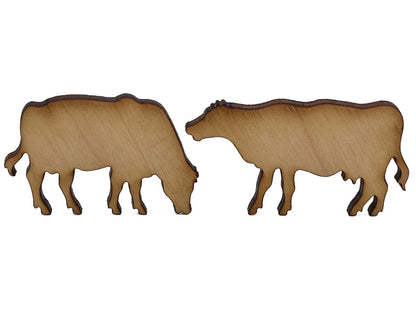 A closeup of pieces shaped like two cows.