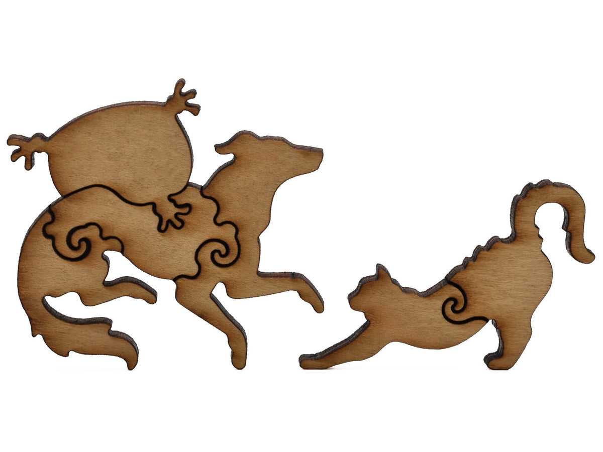 A closeup of pieces shaped like a dog with a pillow and a cat.