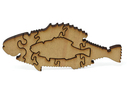 A closeup of pieces showing a multi-piece fish with a small fish inside of it.