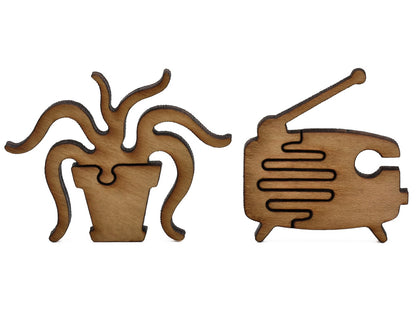 A closeup of pieces shaped like a house plant and an old radio.