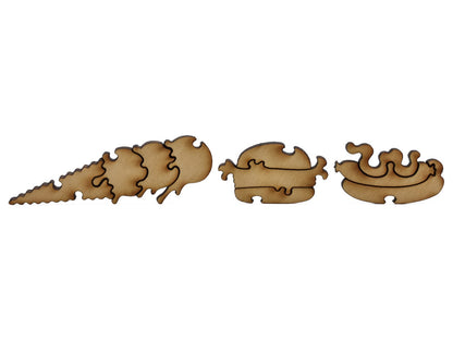 A closeup of pieces shaped like an ice cream, hamburger, and hotdog.