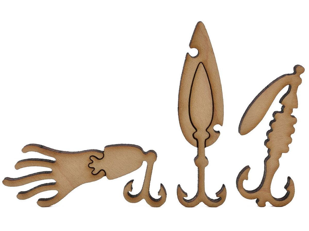 A closeup of pieces shaped like three fishing lures.