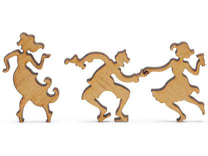 A closeup of pieces shaped like two people dancing while a third one dances near them.