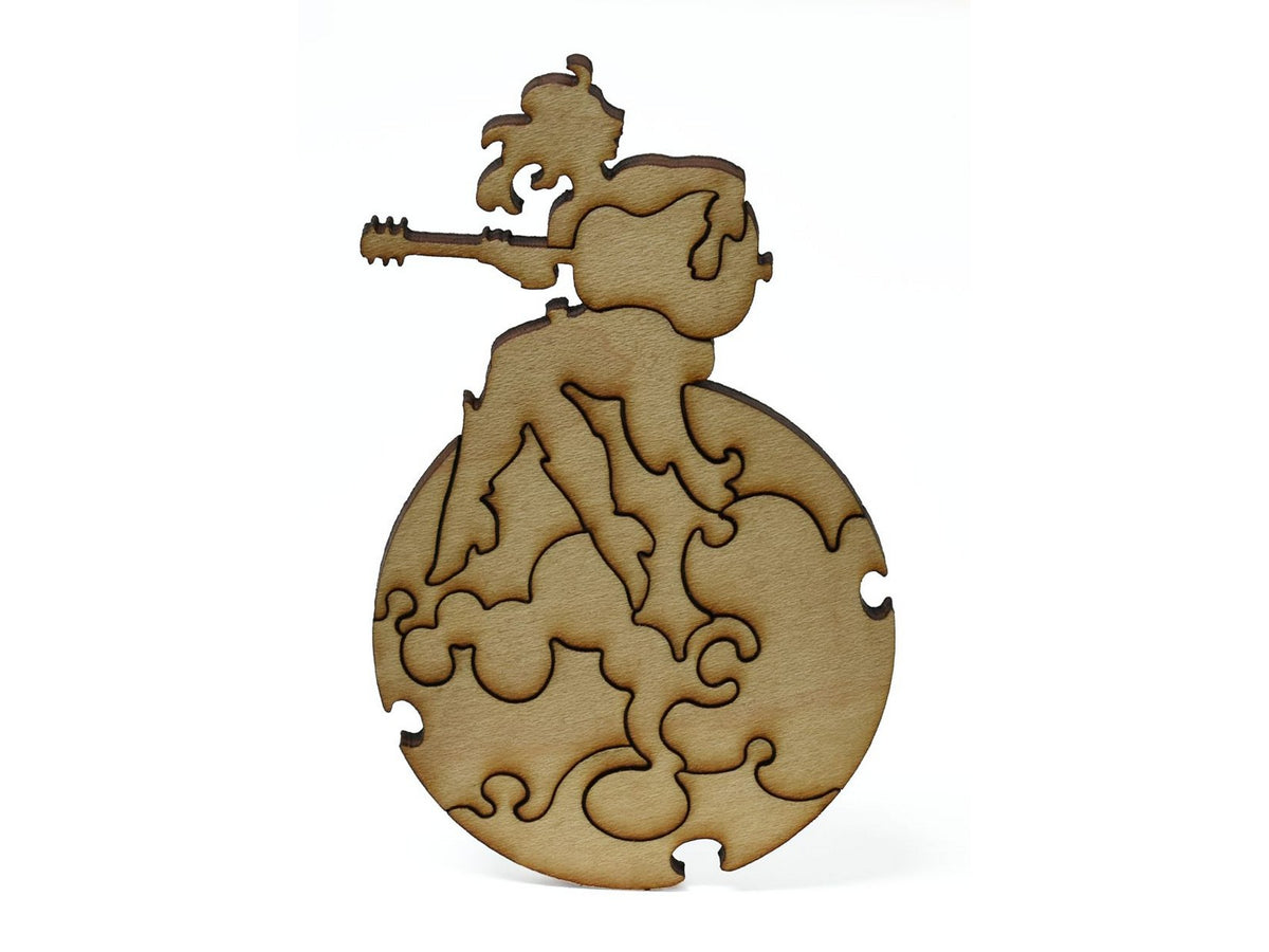 A closeup of pieces showing a woman playing guitar on the moon.