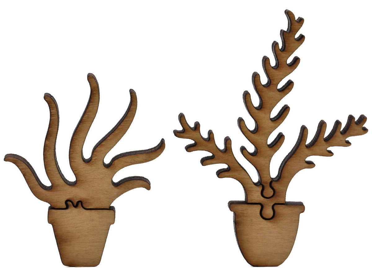 A closeup of pieces shaped like two house plants.