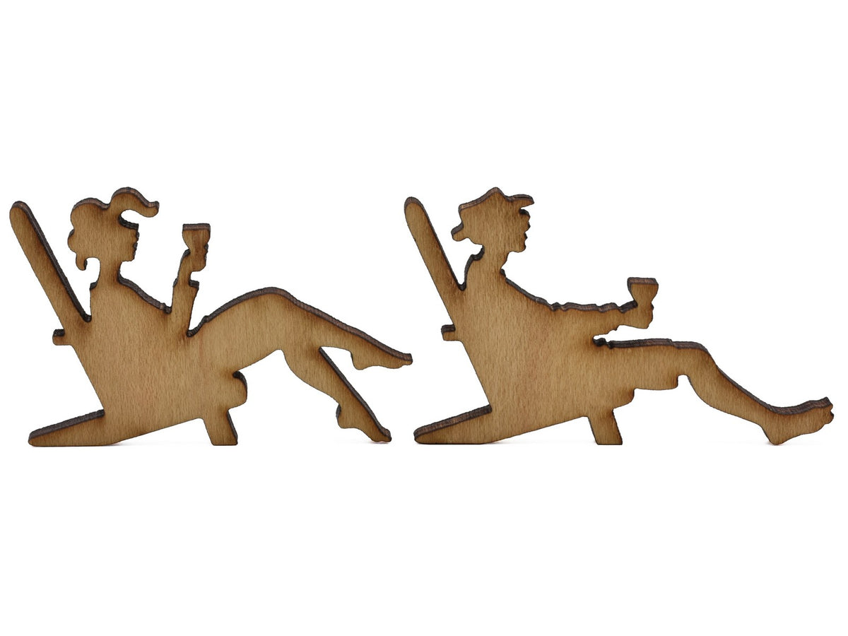 A closeup of pieces shaped like two people sitting in lawn chairs.