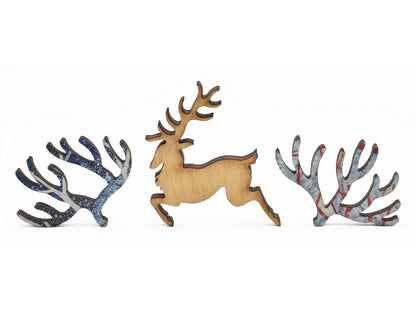 A closeup of pieces in the shape of a deer and branches.