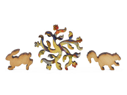 A closeup of pieces in the shape of a rabbit, a flower ornament, and a squirrel.