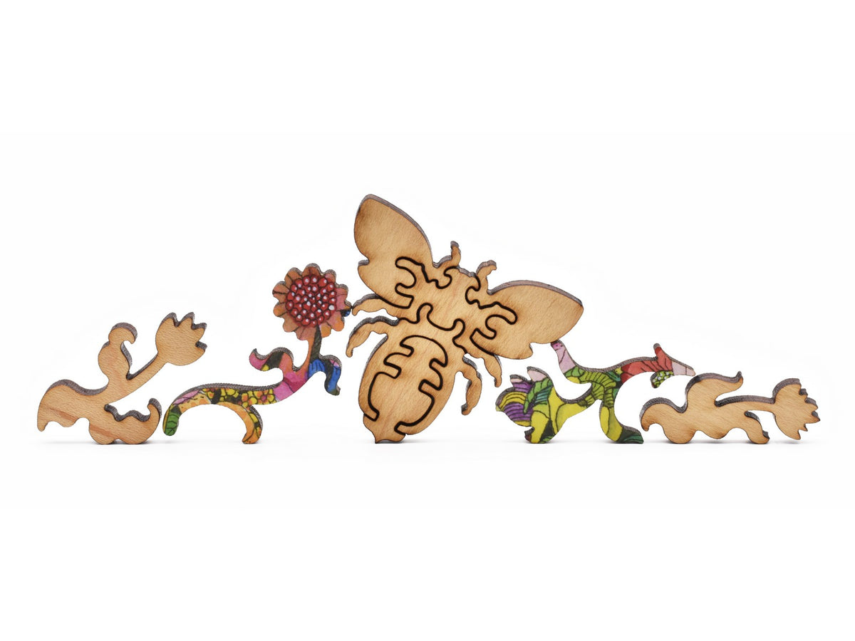 A closeup of pieces in the shape of a bee and flowers.
