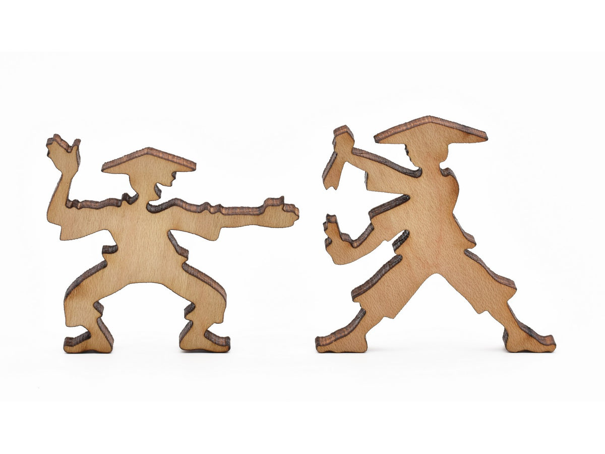A closeup of pieces in the shape of practicing martial arts. 