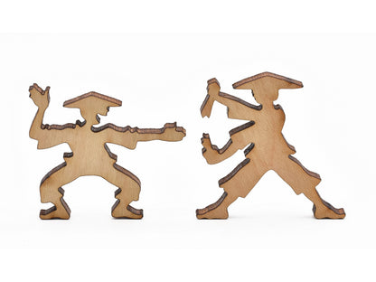 A closeup of pieces in the shape of practicing martial arts. 