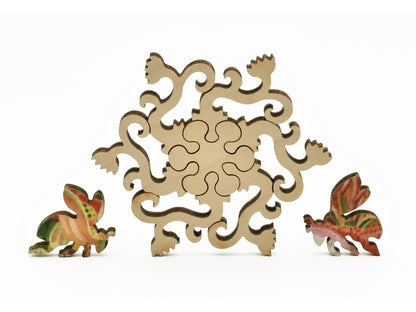 A closeup of pieces in the shape of a flowering vine and bees.