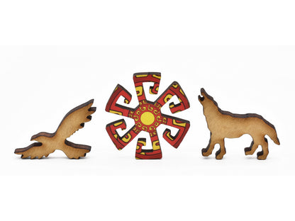 A closeup of pieces in the shape of a bird, a wolf, and a geometric shape.