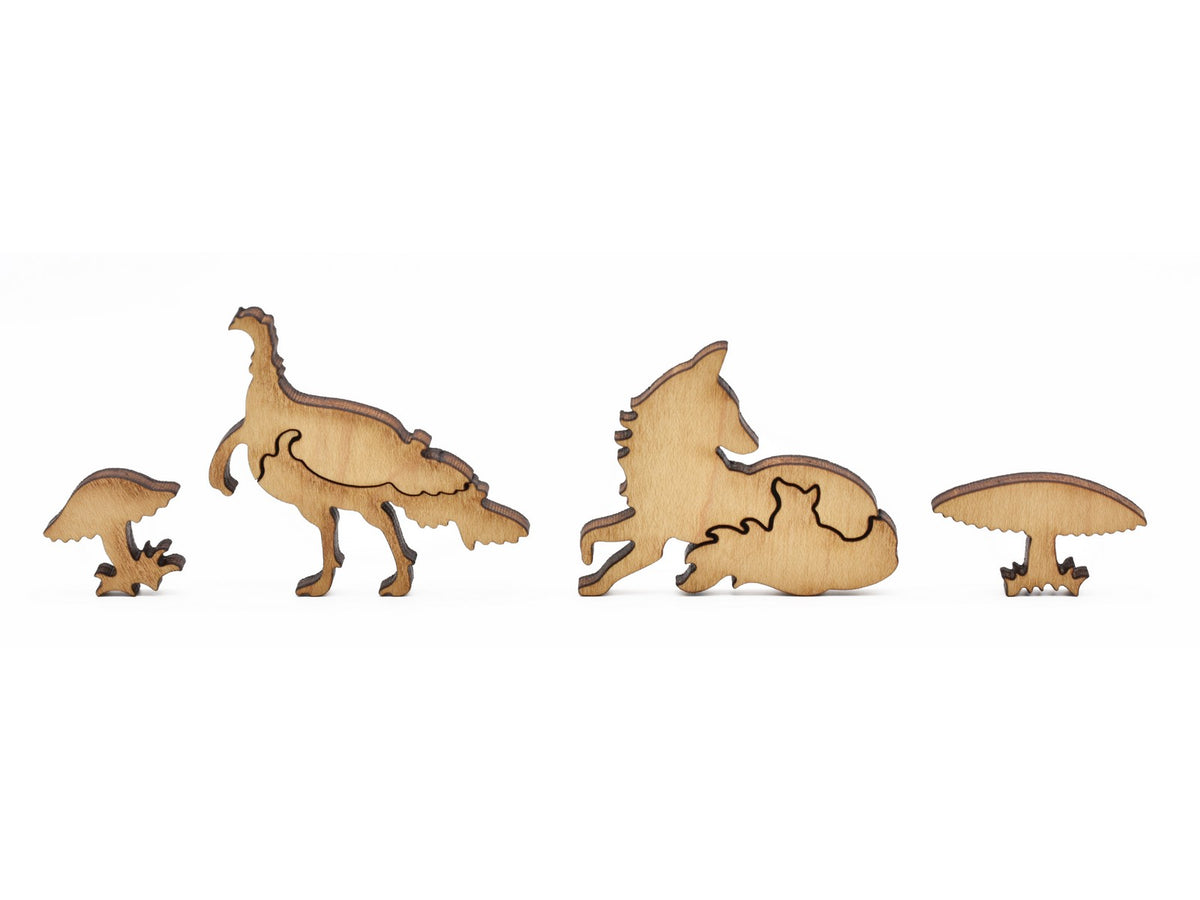 A closeup of pieces in the shape of a turkey, a fox, and mushrooms.