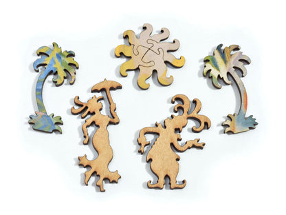 A closeup of pieces in the shape of the sun, two people and two palm trees.