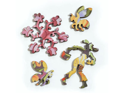 A closeup of pieces in the shape of flowers, bees, and a gardener.