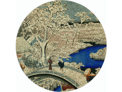 The front of the puzzle, Meguro Drum Bridge, which shows a Japanese style woodblock print of people crossing a bridge over a river.