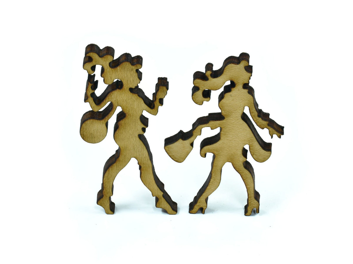 A closeup of pieces in the shape of two women. 