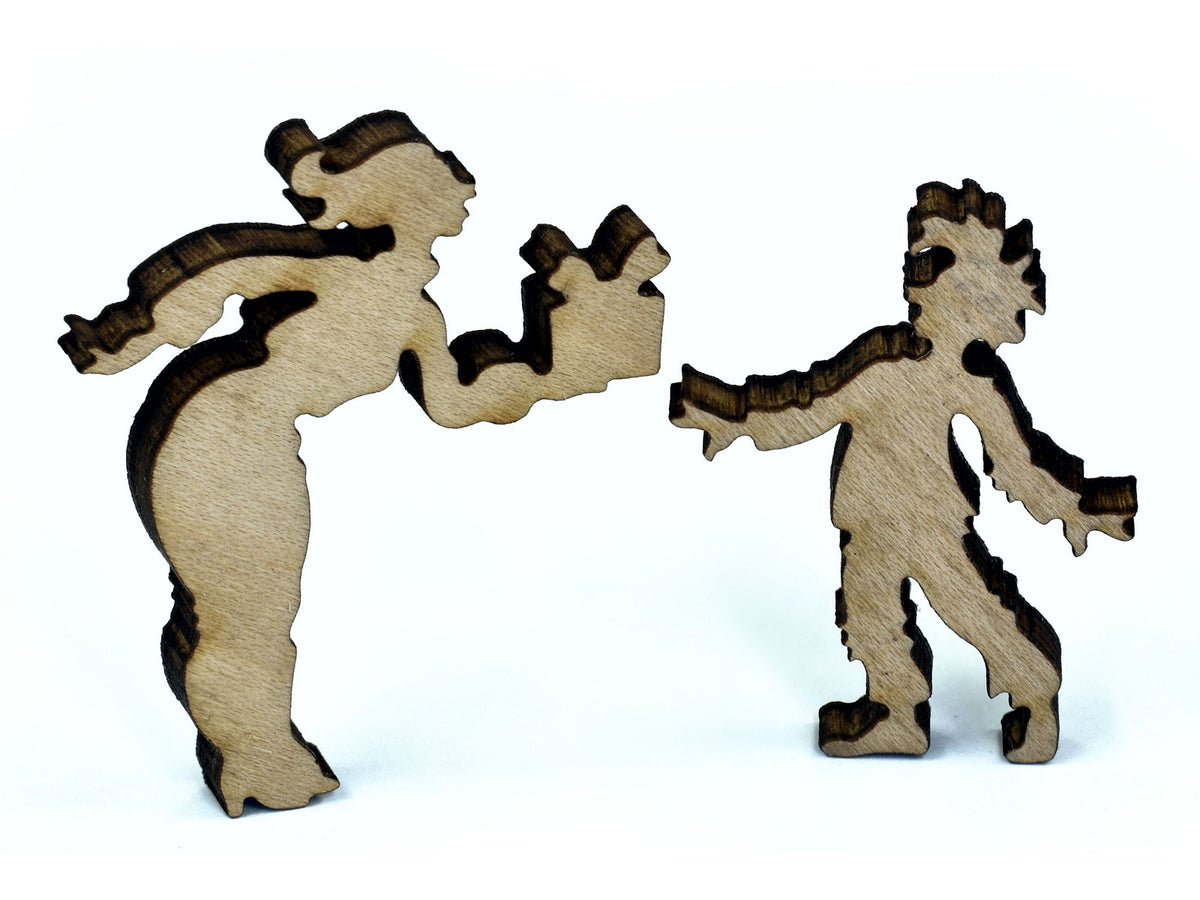 A closeup of pieces in the shape of a woman giving a child a present.
