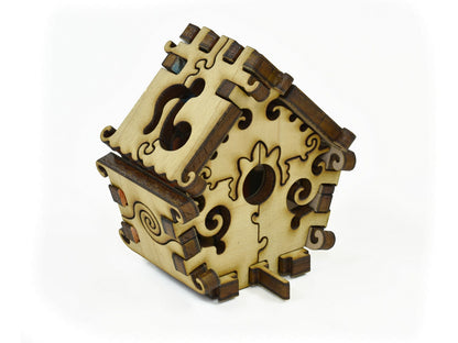 A closeup of pieces in the shape of a 3D Birdhouse.