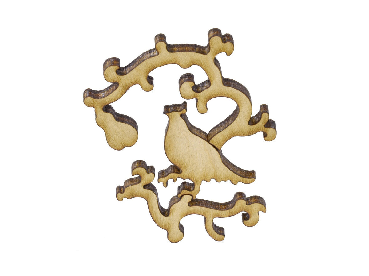 A closeup of pieces in the shape of a partridge in a pear tree.